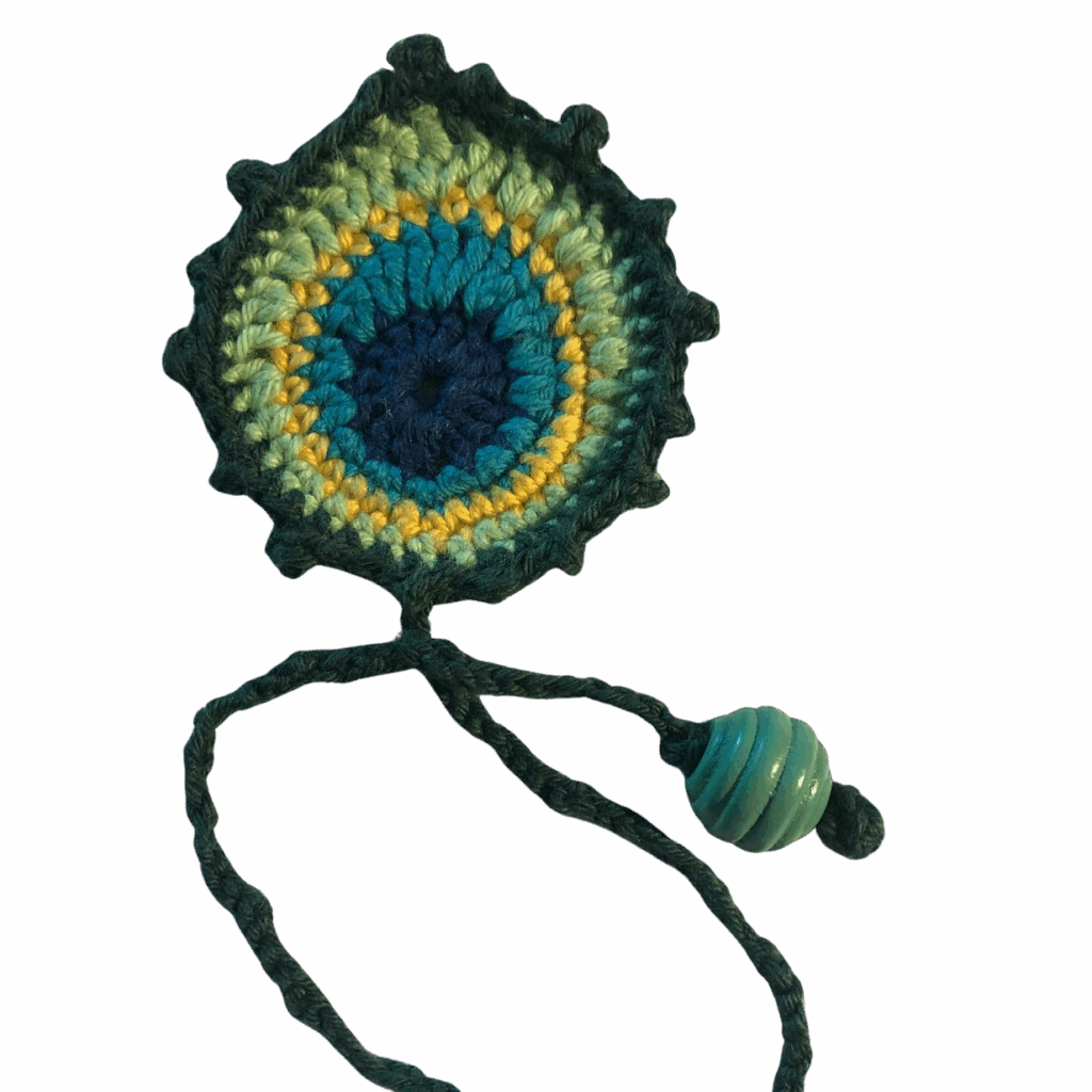 A crocheted peacock bookmark.