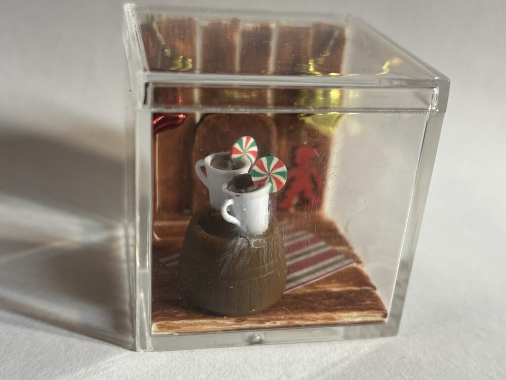 A Christmassy miniature with two mugs and a door